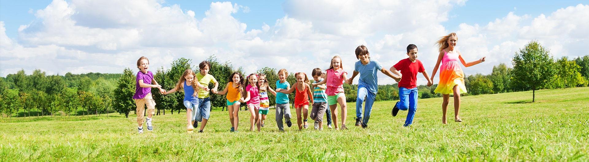 Kids running in field - Pediatric Dentist in Ann Arbor, MI